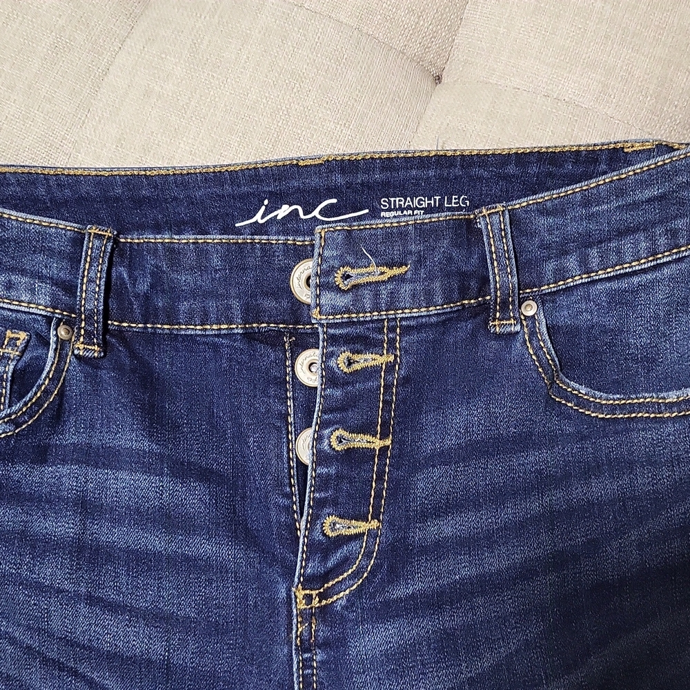 INC fringed bottom jeans.